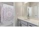 Bathroom with a shower/tub combo and a vanity with decorative mirror and lighting at 434 W 128Th Dr, Westminster, CO 80234