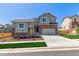A beautifully landscaped two-story home with a brick facade, a spacious driveway, and a well-manicured lawn at 434 W 128Th Dr, Westminster, CO 80234