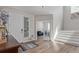 Bright foyer features wood floors, a staircase, and views into the living spaces beyond at 434 W 128Th Dr, Westminster, CO 80234