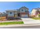 Charming two-story home featuring brick accents, neutral siding, a well-manicured lawn, and a two-car garage at 434 W 128Th Dr, Westminster, CO 80234