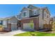 Charming two-story home featuring brick accents, neutral siding, a well-manicured lawn, and a two-car garage at 434 W 128Th Dr, Westminster, CO 80234