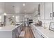 Modern kitchen featuring gray cabinets, stainless steel appliances, a large island, and wood-look flooring at 434 W 128Th Dr, Westminster, CO 80234