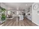Bright kitchen with gray cabinets, stainless appliances, large island with bar seating, and open dining area at 434 W 128Th Dr, Westminster, CO 80234