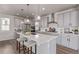 Spacious kitchen with gray cabinets, stainless steel appliances, large island with white countertop, and bar stools at 434 W 128Th Dr, Westminster, CO 80234