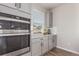 A modern kitchen featuring stainless steel appliances, gray cabinets, and white countertops at 434 W 128Th Dr, Westminster, CO 80234