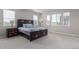 A bedroom with a large bed, carpet flooring, and multiple windows at 434 W 128Th Dr, Westminster, CO 80234