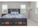 Bedroom with carpet flooring, multiple windows, and a dark wood bed frame with side tables and lamps at 434 W 128Th Dr, Westminster, CO 80234
