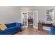 Office space with french doors features luxury vinyl plank flooring, a desk, and a couch at 434 W 128Th Dr, Westminster, CO 80234