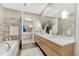 Bright bathroom featuring double sinks, a large mirror, tiled walls, and a soaking tub at 7600 Landmark Way # 1514, Greenwood Village, CO 80111