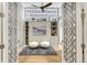 Stylish bedroom features lighted shelving, a modern ceiling fan and patterned doors at 7600 Landmark Way # 1514, Greenwood Village, CO 80111