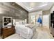 Cozy bedroom featuring a wood accent wall, mirrored closet, and tray ceiling with modern lighting at 7600 Landmark Way # 1514, Greenwood Village, CO 80111