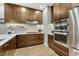 Gourmet kitchen showcasing stainless steel appliances and custom wood cabinetry at 7600 Landmark Way # 1514, Greenwood Village, CO 80111