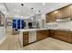Modern kitchen features stainless steel appliances, a large island, and custom wood cabinets at 7600 Landmark Way # 1514, Greenwood Village, CO 80111