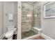 Modern tiled shower with glass door, rainfall showerhead, and convenient built-in bench at 7600 Landmark Way # 1514, Greenwood Village, CO 80111
