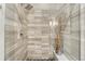 Modern bathroom shower featuring gray tiles, a glass door, and a rainfall showerhead at 7600 Landmark Way # 1514, Greenwood Village, CO 80111