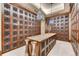 Impressive wine cellar with custom storage and a tasting table, perfect for wine enthusiasts to showcase their collection at 7600 Landmark Way # 1514, Greenwood Village, CO 80111