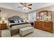 Cozy primary bedroom features a ceiling fan and a classic wooden dresser with mirror at 13781 E Marina Dr # A, Aurora, CO 80014
