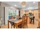 Dining room area with view of the sliding door, hardwood floors, and open kitchen at 13781 E Marina Dr # A, Aurora, CO 80014