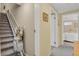 Accessible hallway with a stair lift, neutral paint, and carpeted stairs at 13781 E Marina Dr # A, Aurora, CO 80014