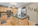 Eat-in kitchen features stainless appliances, granite countertops, and an island with extra storage at 13781 E Marina Dr # A, Aurora, CO 80014