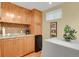 Well-lit kitchenette with light wood cabinets, tile backsplash, and modern appliances at 13781 E Marina Dr # A, Aurora, CO 80014