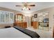 Bright main bedroom featuring shuttered windows, large closets, and ample space for a dresser at 13781 E Marina Dr # A, Aurora, CO 80014