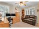 Cozy home office setup with a large desk, comfortable seating, and natural light from shuttered windows at 13781 E Marina Dr # A, Aurora, CO 80014