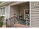Inviting covered porch with seating area, stylish décor, and charming exterior details at 13781 E Marina Dr # A, Aurora, CO 80014