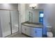 Double vanity bathroom with a large shower and granite countertop at 15700 E Jamison Dr # 5-307, Englewood, CO 80112
