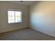 Spacious bedroom with large window and neutral carpeting at 15700 E Jamison Dr # 5-307, Englewood, CO 80112