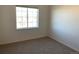Bright bedroom with large window and neutral carpeting at 15700 E Jamison Dr # 5-307, Englewood, CO 80112