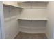 Large walk-in closet with double hanging rods and shelves at 15700 E Jamison Dr # 5-307, Englewood, CO 80112