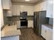 Modern kitchen with stainless steel appliances and granite countertops at 15700 E Jamison Dr # 5-307, Englewood, CO 80112