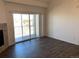 Living room with hardwood floors, fireplace, and access to balcony at 15700 E Jamison Dr # 5-307, Englewood, CO 80112