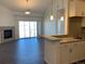 Bright living room with fireplace and sliding glass doors to patio at 15700 E Jamison Dr # 5-307, Englewood, CO 80112