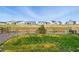 Grassy backyard with view of the neighborhood and a wood fence at 1101 E Witherspoon Dr, Elizabeth, CO 80107