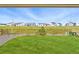 The backyard includes a wooden fence and views of the neighborhood with green space at 1101 E Witherspoon Dr, Elizabeth, CO 80107