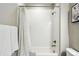 Bright, white tiled bathroom with a shower-tub combo at 1101 E Witherspoon Dr, Elizabeth, CO 80107