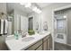 Bathroom featuring double sinks with modern fixtures, a large mirror, and ample counter space at 1101 E Witherspoon Dr, Elizabeth, CO 80107