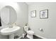 Stylish powder room featuring a pedestal sink and modern artwork creating a fresh, inviting space at 1101 E Witherspoon Dr, Elizabeth, CO 80107