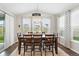 Dining room filled with natural light, featuring a large wood table and neutral decor at 1101 E Witherspoon Dr, Elizabeth, CO 80107