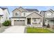 Attractive two-story home featuring a two-car garage, well-kept lawn, and modern architectural design at 1101 E Witherspoon Dr, Elizabeth, CO 80107