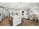 Bright, open kitchen with granite counters island flows into living room with fireplace and staircase at 1101 E Witherspoon Dr, Elizabeth, CO 80107