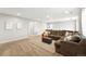 Expansive living area with a plush sectional, ottoman, and neutral tones, perfect for relaxation and entertaining at 1101 E Witherspoon Dr, Elizabeth, CO 80107