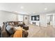Spacious living room with a comfortable sectional sofa, plush rug, and entertainment center creating a cozy atmosphere at 1101 E Witherspoon Dr, Elizabeth, CO 80107
