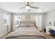 Bright main bedroom with a stylish bed, nightstands, and ample natural light, creating a serene and welcoming space at 1101 E Witherspoon Dr, Elizabeth, CO 80107