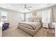 Bright main bedroom featuring a cozy bed, soft carpet, and natural light from large windows creating a peaceful retreat at 1101 E Witherspoon Dr, Elizabeth, CO 80107