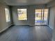 Living room with sliding glass door and several windows overlooking the neighborhood at 1652 N Lafayette St # 1, Denver, CO 80218