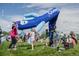 Children playing with a large, inflatable toy and bubbles in an outdoor park setting at 1652 N Lafayette St # 1, Denver, CO 80218