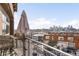 Balcony view showcasing the city skyline with patio seating and an umbrella for shade and enjoying the sunshine at 1925 W 32Nd Ave # 502, Denver, CO 80211